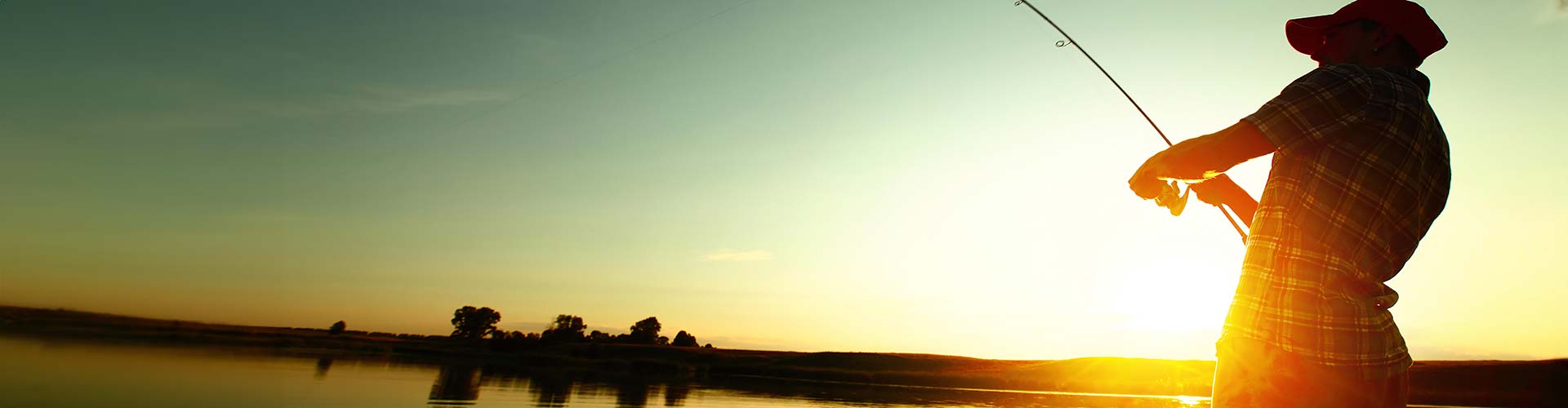 Sunset over a North Georgia lake with man fishing