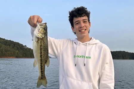  Young adult poses with 4-hour fishing trip catch.