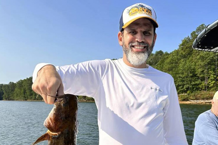  Man holds up 6-hour lake fishing catch.