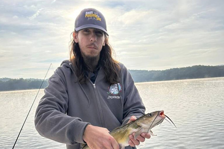  Man poses solo with lake trip fish.